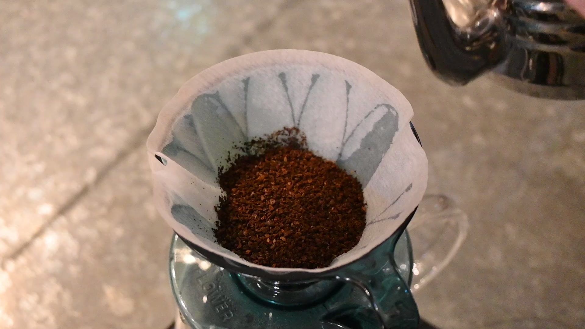 After rinsing the paper, set the grounds in the Flower Dripper